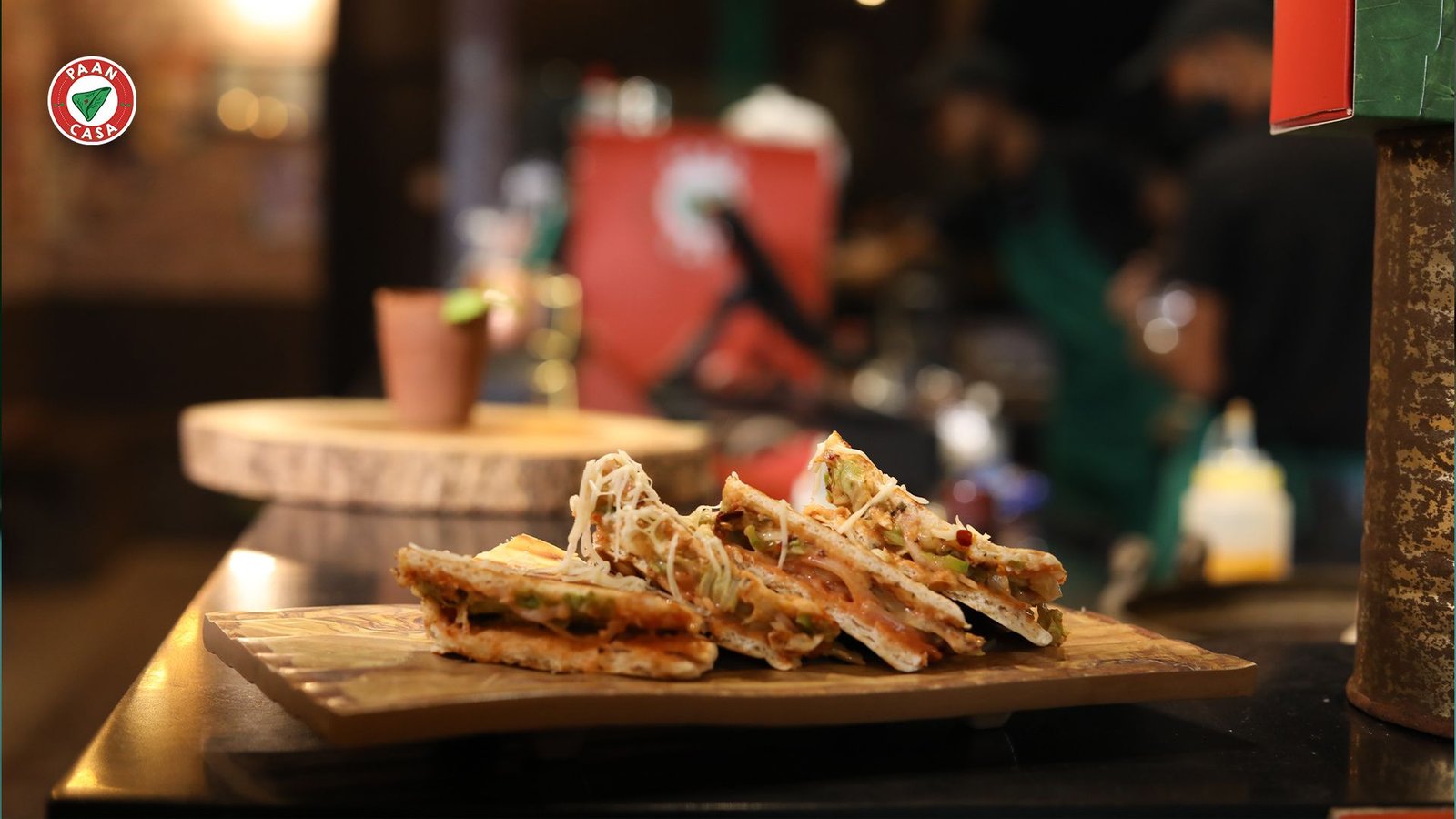 Gourmet Indian street food served on a wooden board at a premium paan cafe, showcasing the modern upgrade of traditional Indian street food culture.