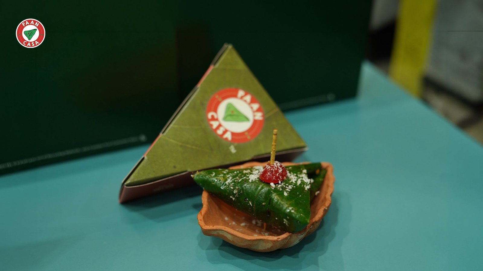 Traditional sweet paan beautifully presented in a clay dish with a cherry topping, celebrating the perfect way to end a special occasion at a premium paan cafe.
