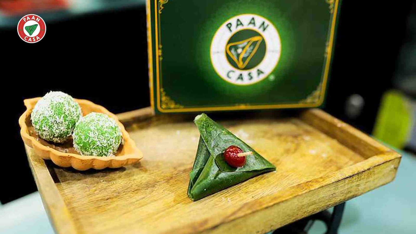Paan desserts and a traditional paan served on a wooden tray.
