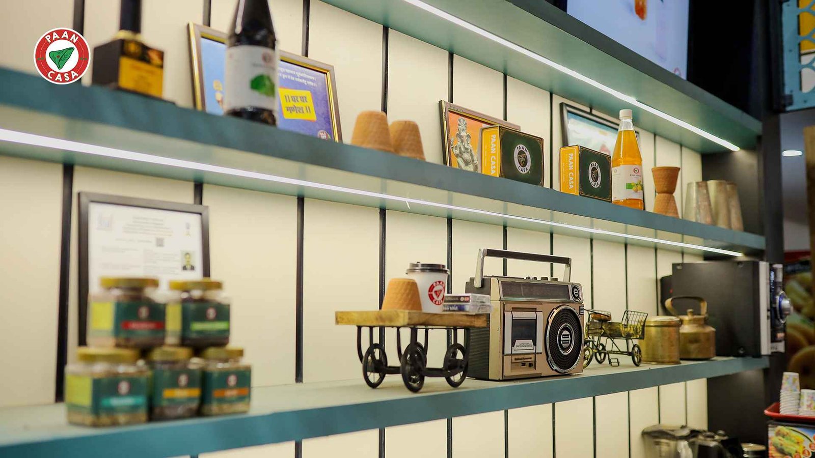 Modern Paan Casa cafe interior with decorative shelves and cultural elements.